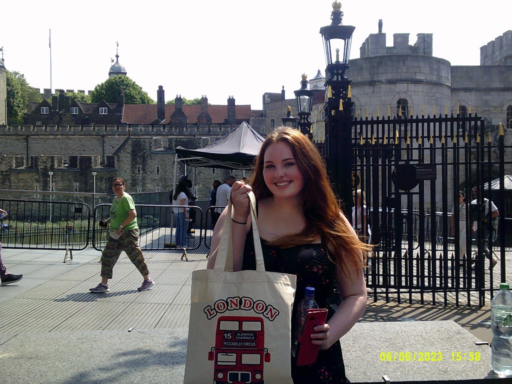 Sarah in London with the Tower of London behind her